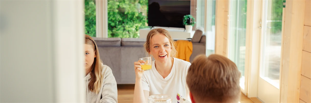 A group of people sitting at a table with food.