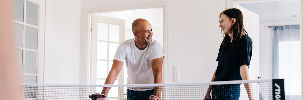 A group of people play ping pong.