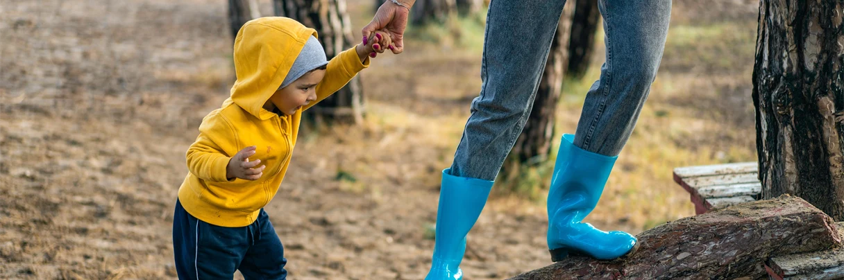 Child and adult on log